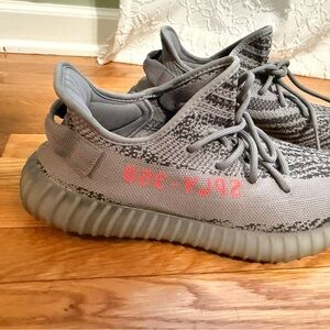 Yeezy Gray Athletic Shoes with Red Accents